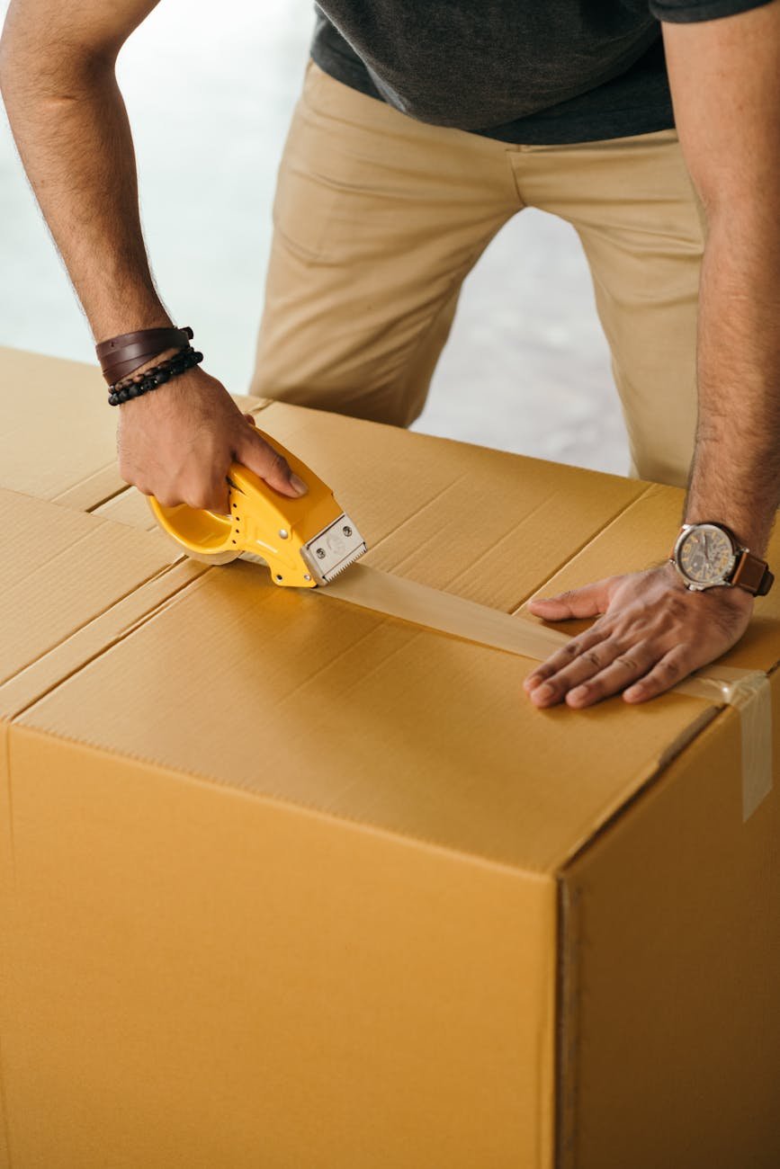 crop man sealing box with scotch tape flipkart