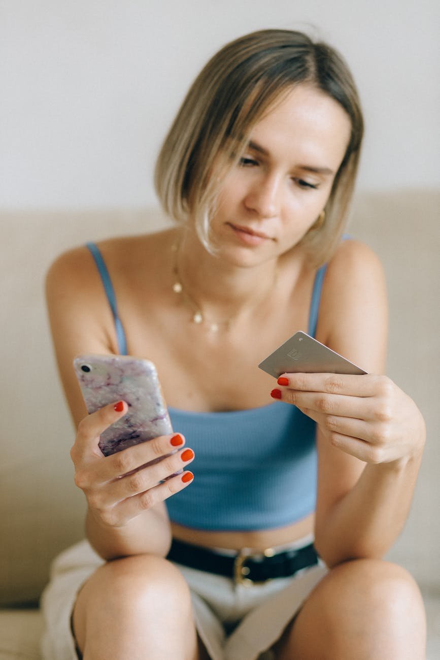 a woman holding her phone and credit card flipkart
